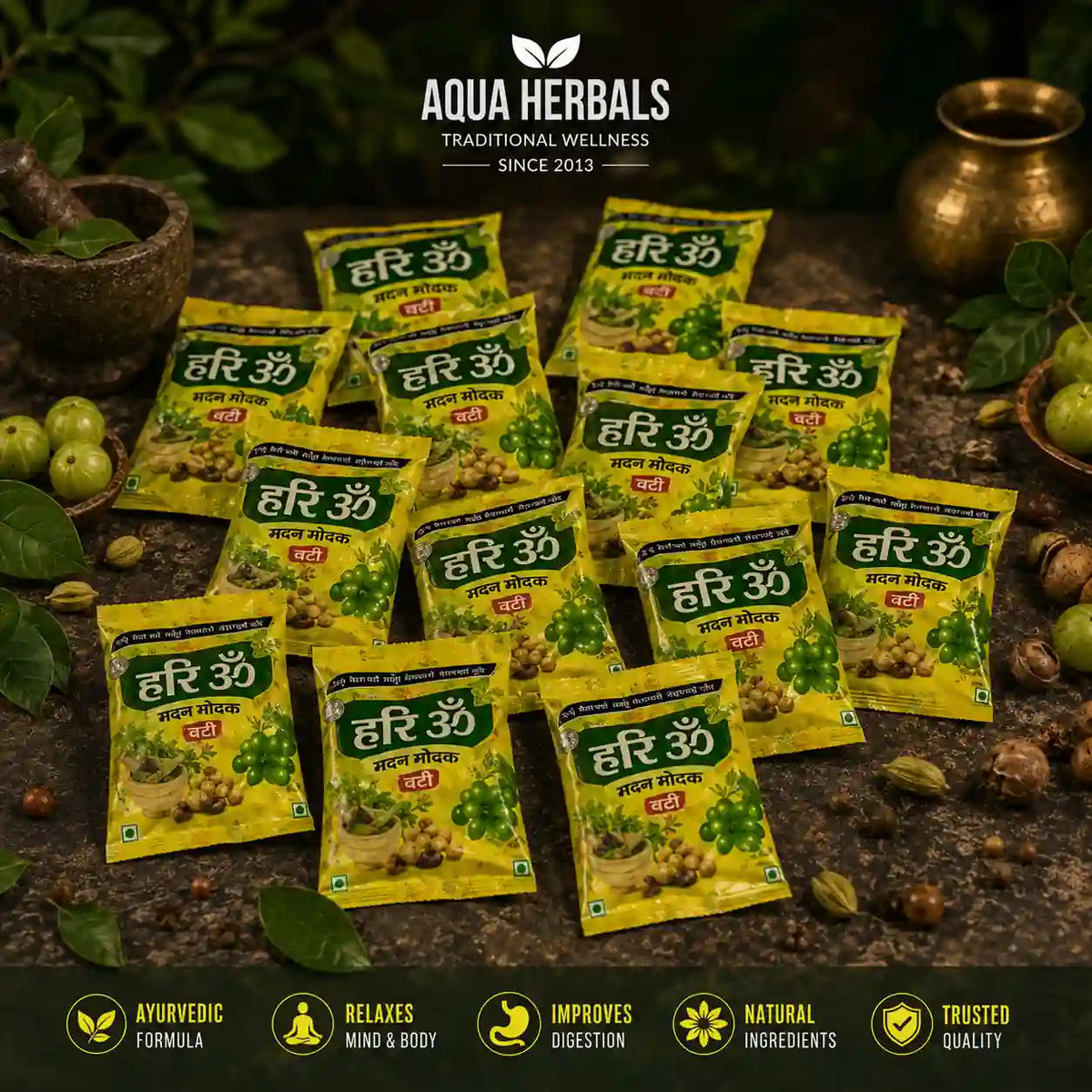 Multiple Hari Om Madan Modak Vati bhang goli sachets arranged on stone with amla and Ayurvedic herbs